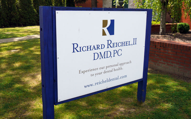 Richard Reichel, II DMD blue and white sign outside of practice